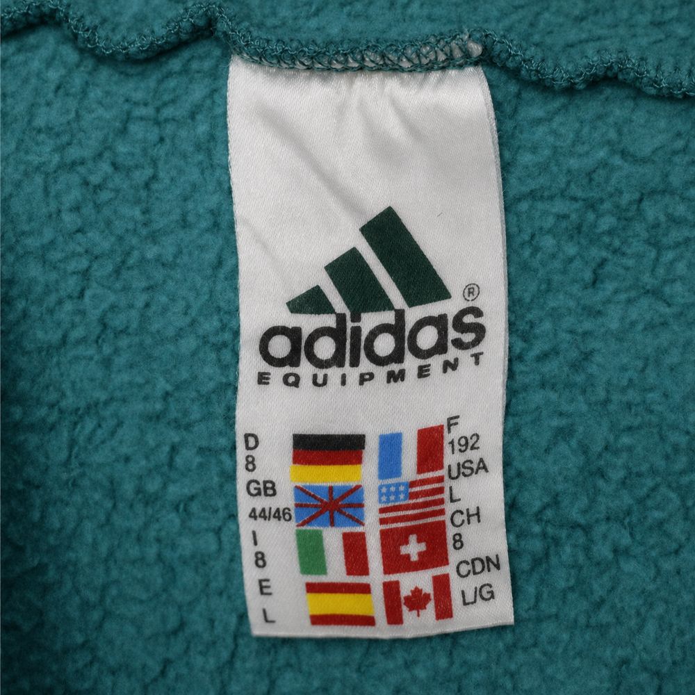 Adidas Equipmentの実物タグ資料、別仕様の織りネーム。縫い付け方にも注目する
