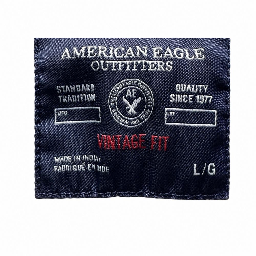 AMERICAN EAGLEのESTABLISHED 1977、S P CH、MADE IN PAKISTAN表示のパーカータグ