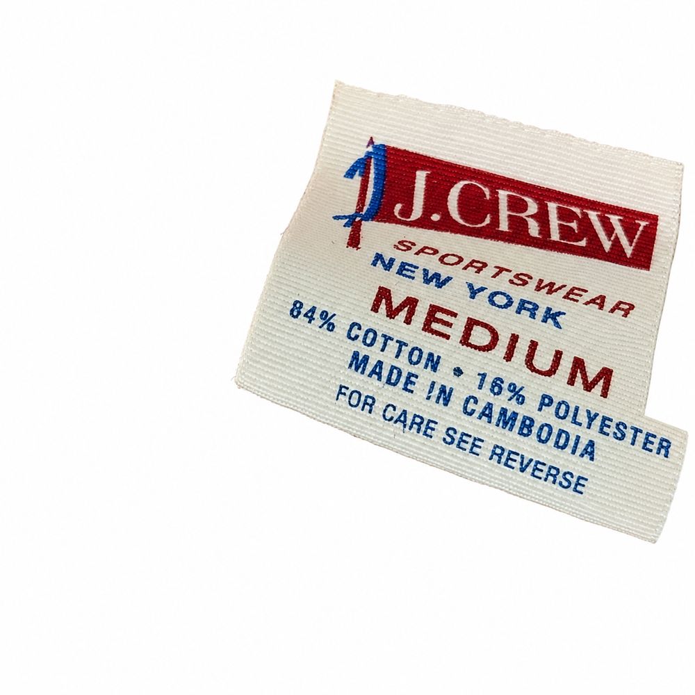 J.CREWのM、100パーセントCOTTON、MADE IN USA、CARE OVER表示のデニムシャツタグ