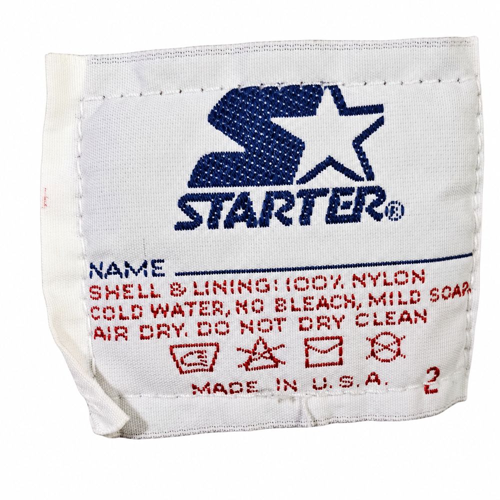 Starterロゴ、ShellとLiningの100パーセントNylon、Made in U.S.A.のケアタグ