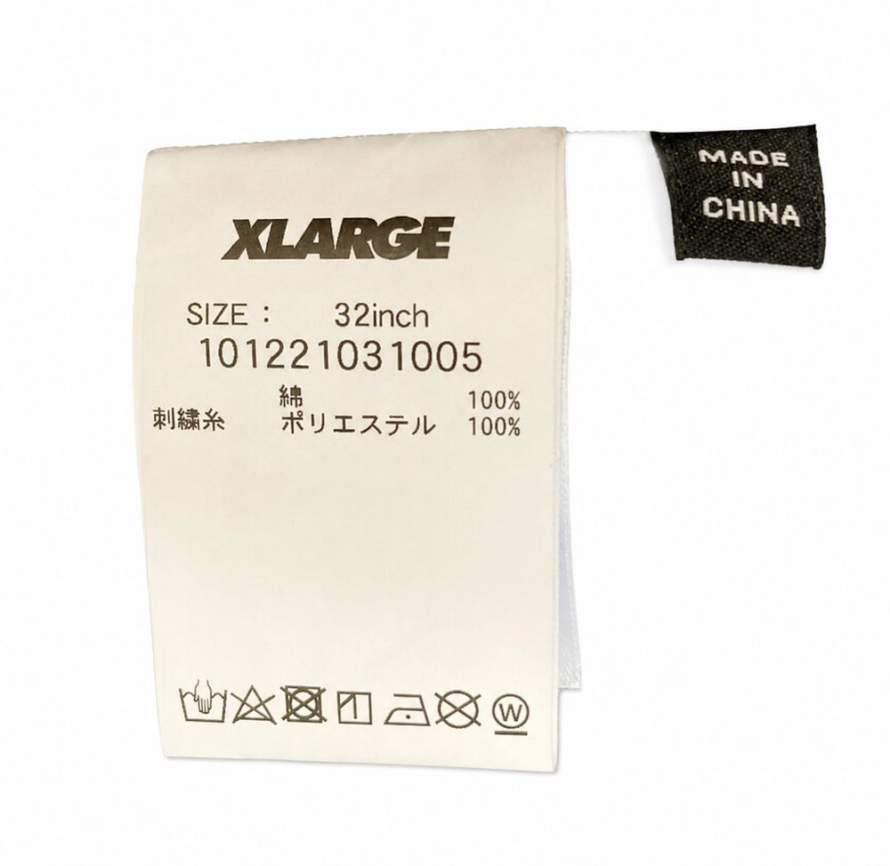X-LARGE、サイズS、品番101221012026、綿とポリウレタン素材のタグ